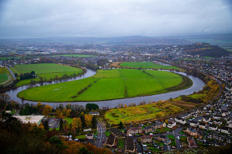 River Flowing In Village In Countryside