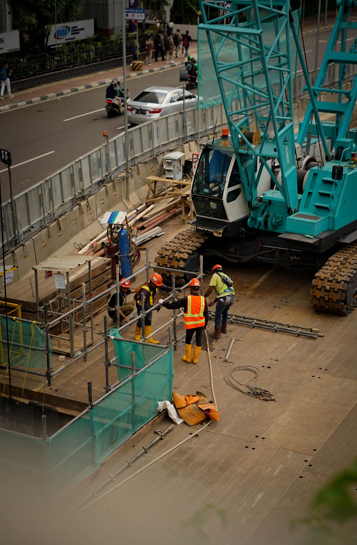 Busy Southeast Asian construction site with workers and machinery, the kind of project that needs both temporary power and site lighting