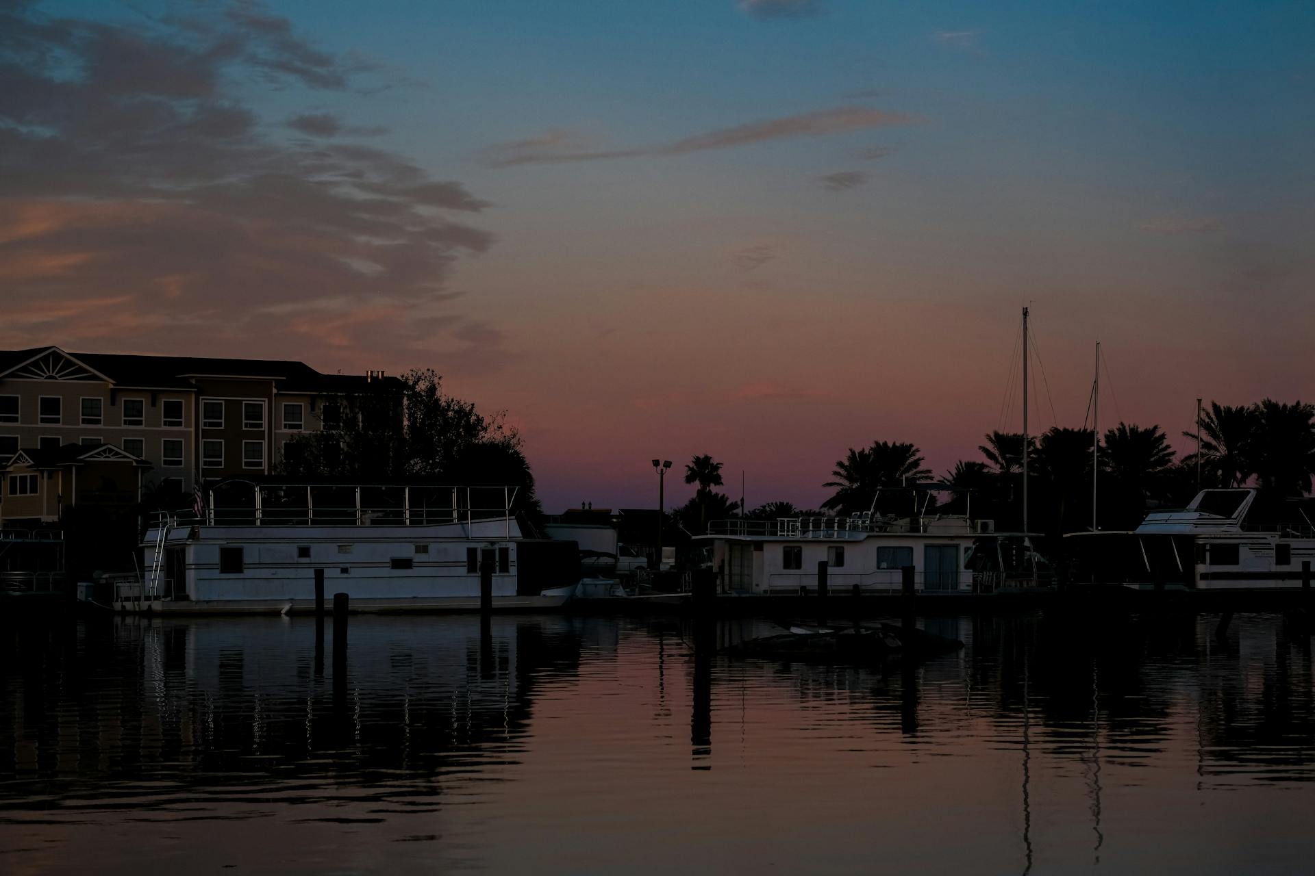 Tranquil evening view of boats docked on a serene waterfront in Florida at sunset.