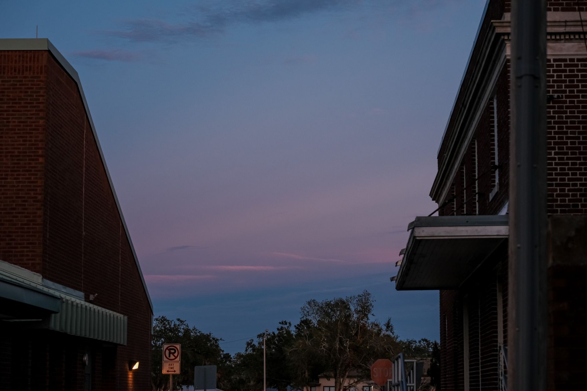 Urban landscape with brick buildings and twilight sky, highlighting architectural design.