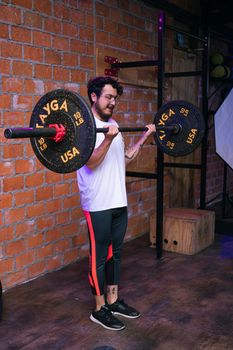 Man performs weightlifting exercise in a Mexico City gym, showcasing strength and dedication.