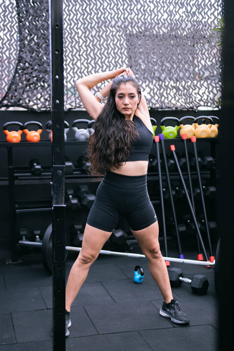 Woman In Sportswear Stretching In Gym