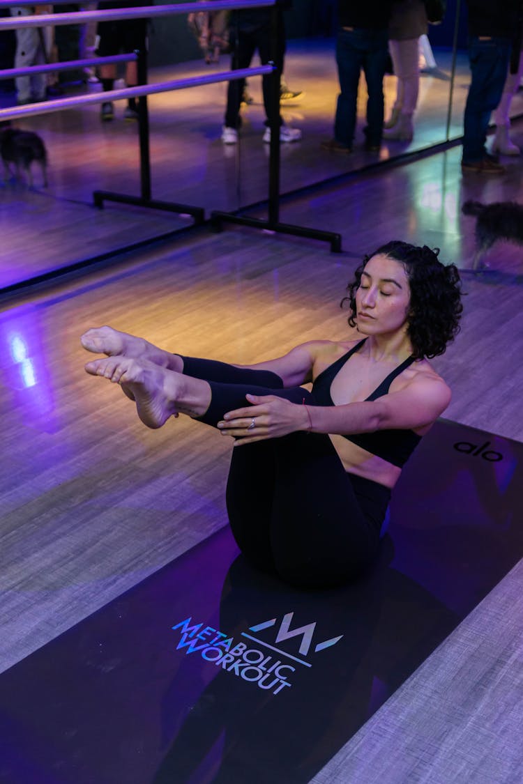 Woman Exercising On Mat