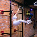 A Woman Doing an Exercise using Pull-Up Bar