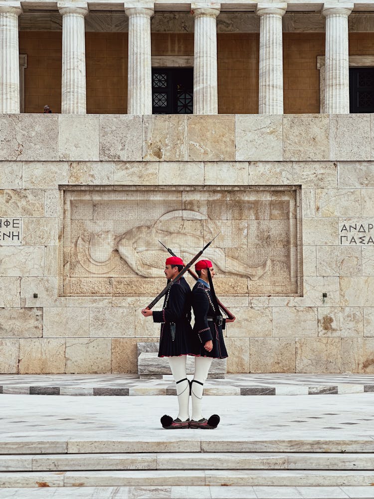 Two Soldiers Standing Back To Back 