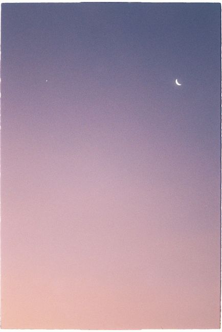 Serene crescent moon and star in a colorful twilight sky, capturing a peaceful evening atmosphere.