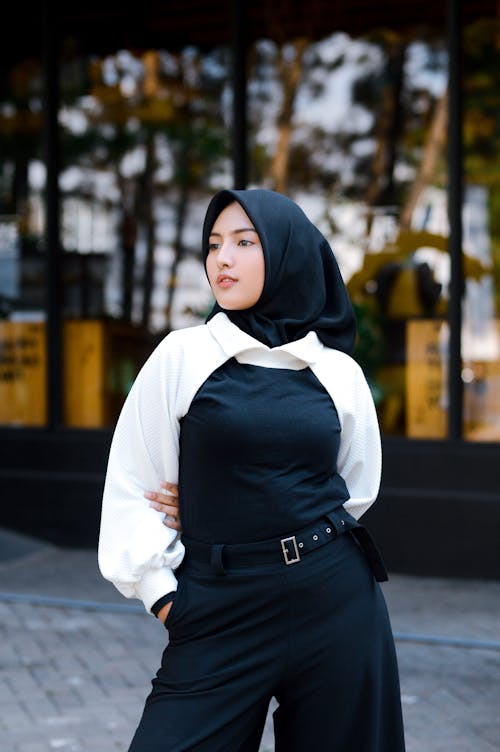 Free A Woman in Black Hijab Standing and Posing on the Street Stock Photo