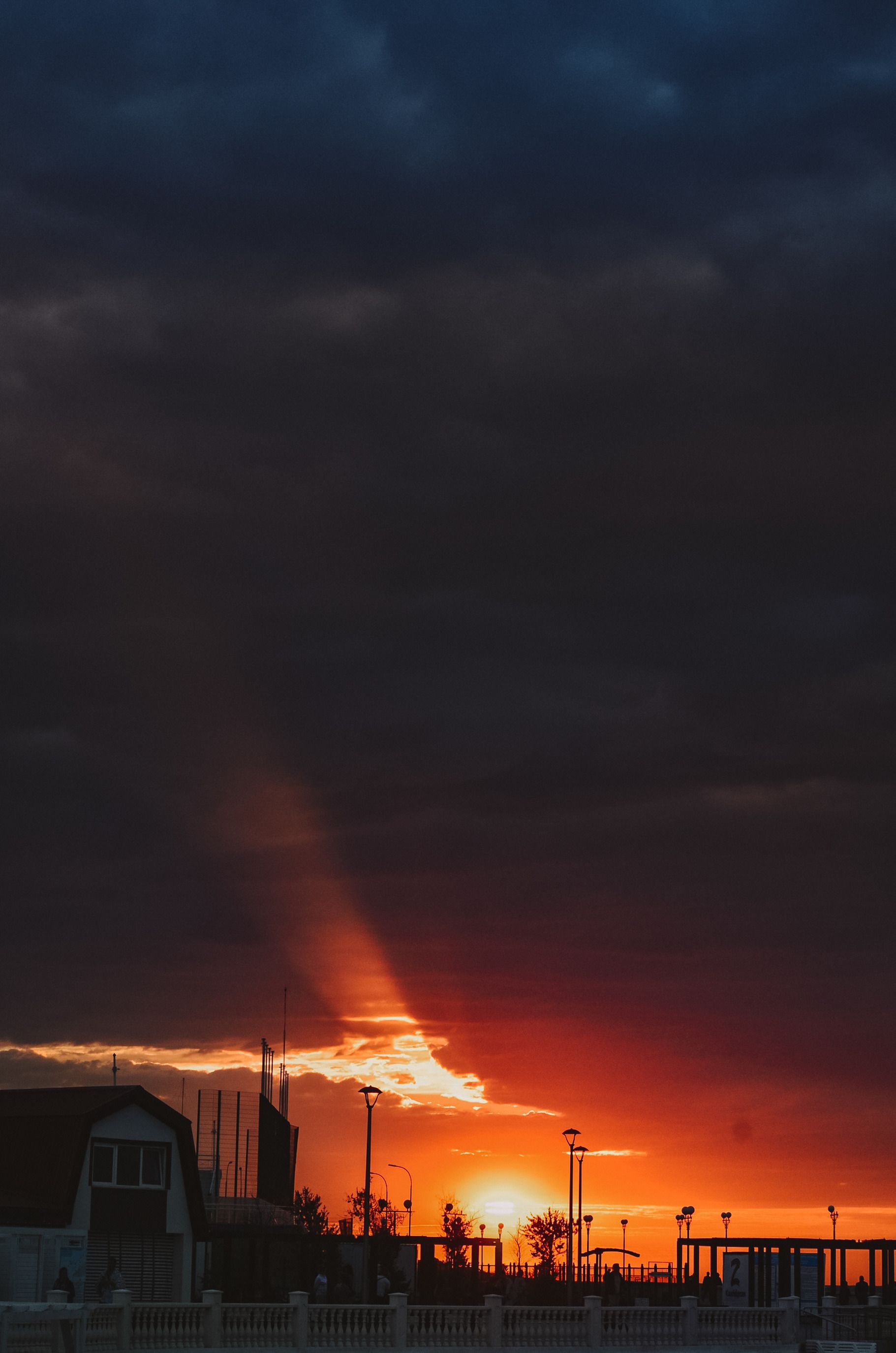 Photo of a Sunset with Dark Stormy Clouds · Free Stock Photo