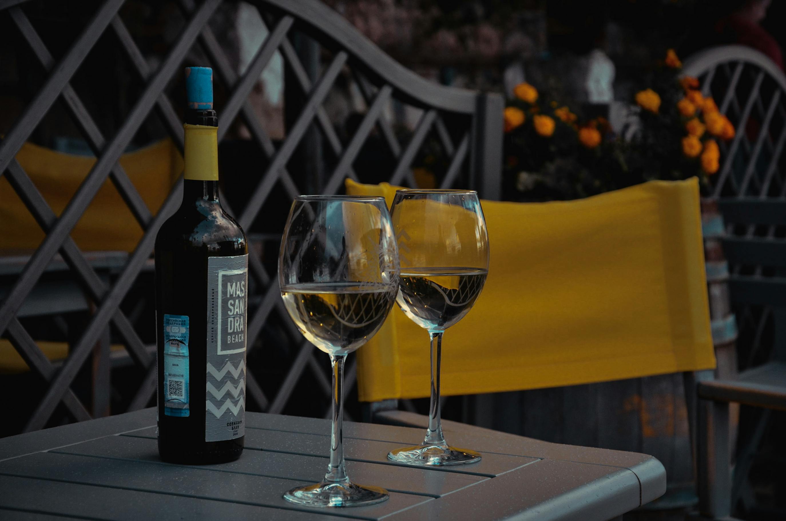 White Wine Glass On A Table With Yellowed Teeth In The Background