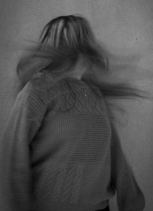 Black and White Blurred Photo of a Woman with Tousled Hair