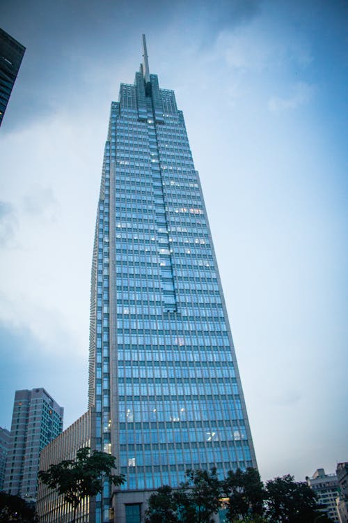 Low Angle Shot of a Blue Glass Skyscraper