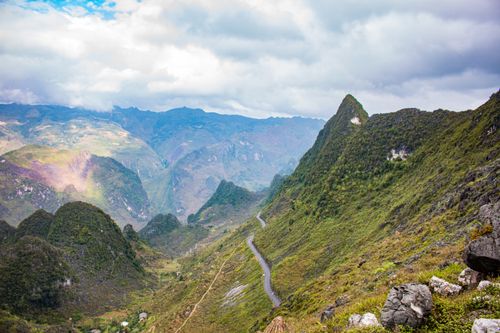 Free Breathtaking vista of green mountains and valleys under a cloudy sky, ideal for nature lovers. Stock Photo