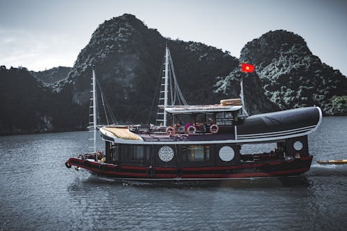 A Ferry Boat on the Water Near the Mountain