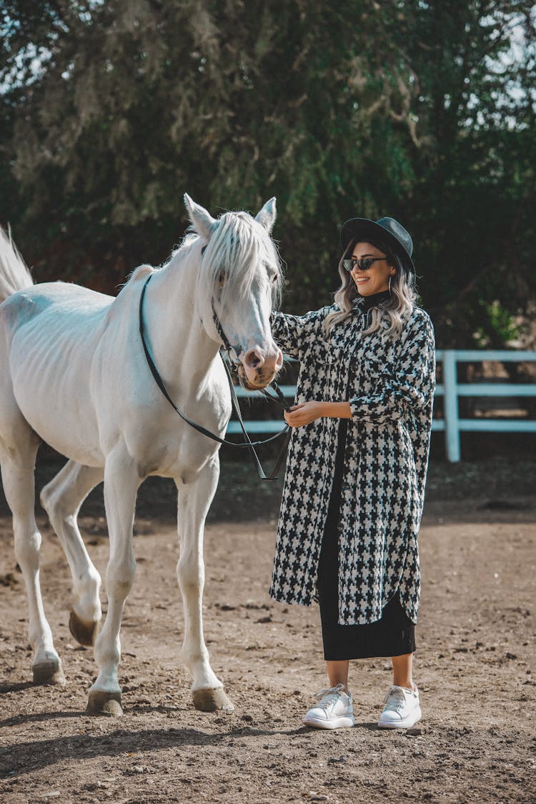 Woman Leading White Horse