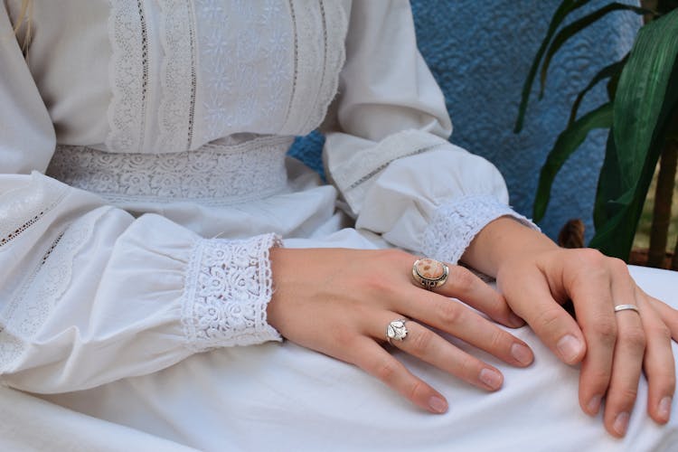 Hands Of Woman In Victorian Dress Wearing Rings