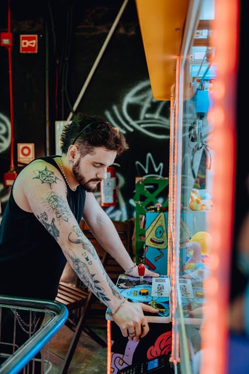 Portrait Of Tattooed Man Playing a Game In Amusement Park