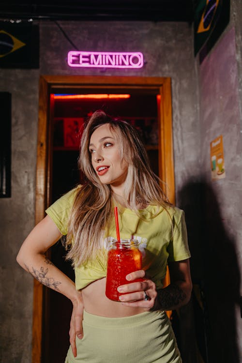 Photo of a Young Woman with a Cocktail in a Nightclub in Brazil