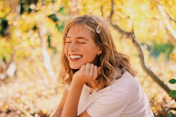 Portrait Of Laughing Woman In Autumn Forest