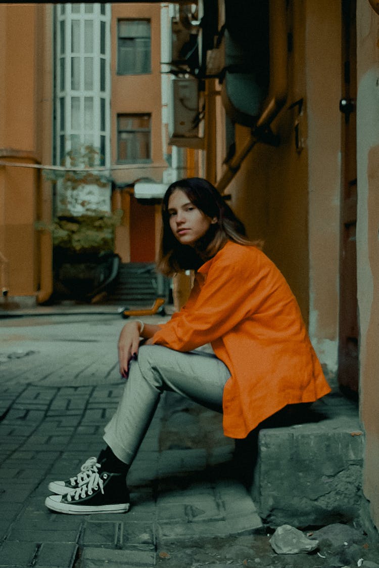 Person Sitting On Concrete Step