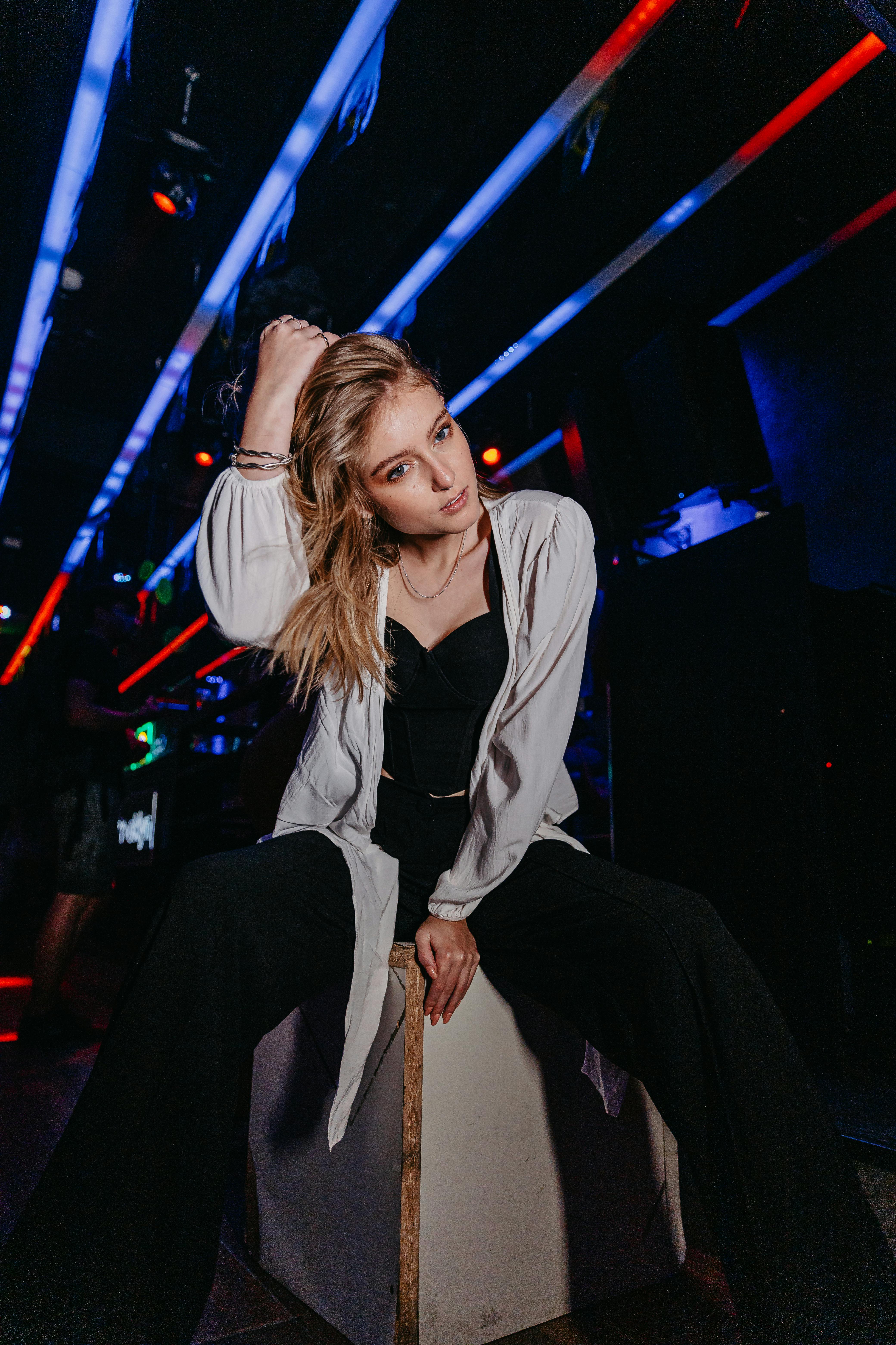 portrait of a beautiful blonde woman sitting in a club