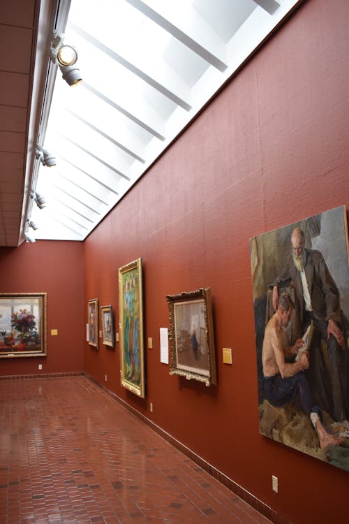 Photo of a Room Full of Paintings in an Art Gallery