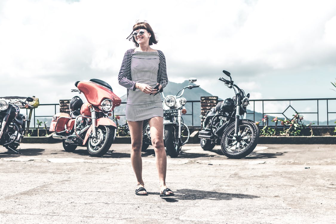 Photo of Woman Near Parked Motorcycles
