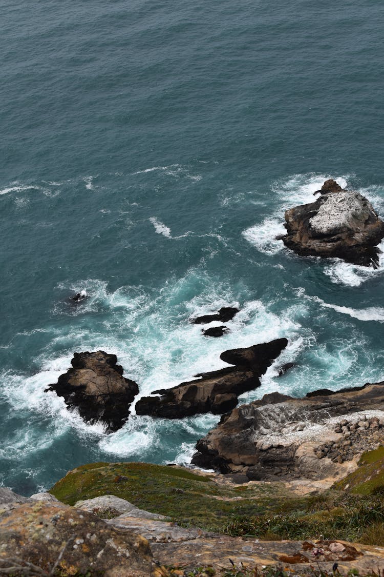 Waves Crashing Onto Rocks By Shore