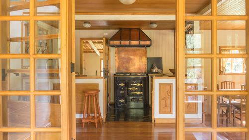 Free Warm rustic kitchen interior featuring a vintage stove and wooden furniture, offering a glimpse of nostalgic charm. Stock Photo