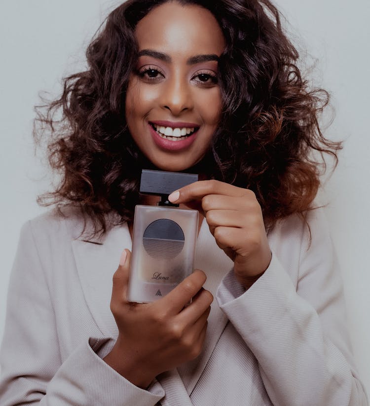 Woman Holding A Bottle Of Perfume 