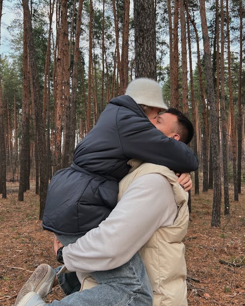 Man Hugging and Lifting a Woman in a Forest 