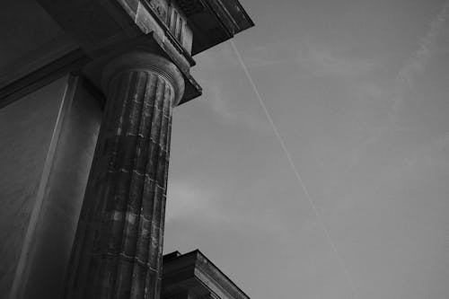 Grayscale Photo of Concrete Column