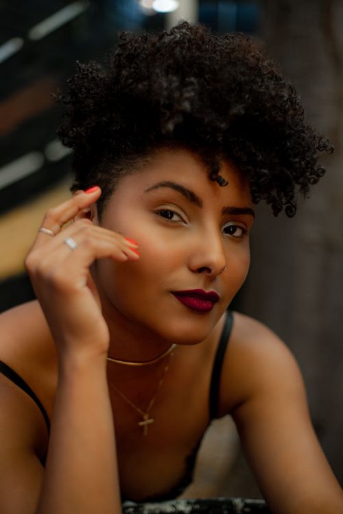 Free Close-up portrait of a beautiful woman with curly hair and bold lipstick. Stock Photo