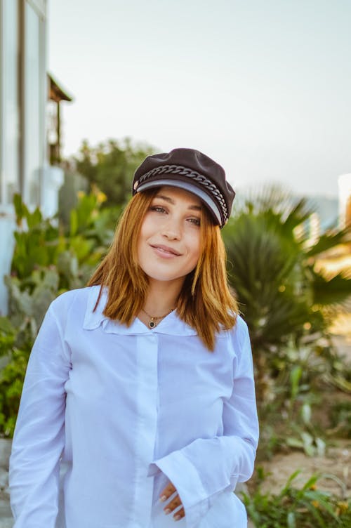 Woman in a White Blouse and a Cap 