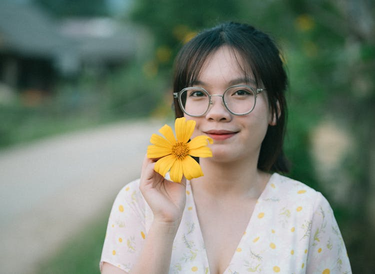 Portrait Of A Woman Holding A Flower