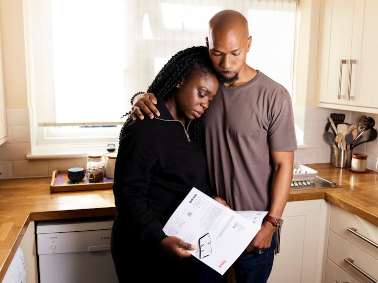 Couple Comforting Each Other In Kitchen