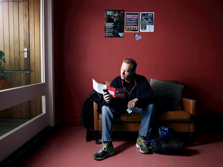 A Man Reading A Leaflet