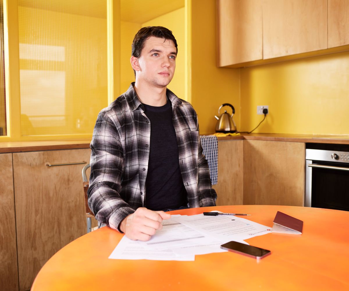 Homeowner reviewing financial documents at a kitchen table