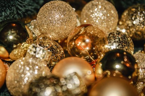 Free A close-up of shimmering golden Christmas ornaments, ideal for festive decor concepts. Stock Photo