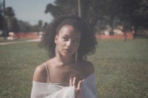 A Woman Wearing Earrings with Curly Hair 