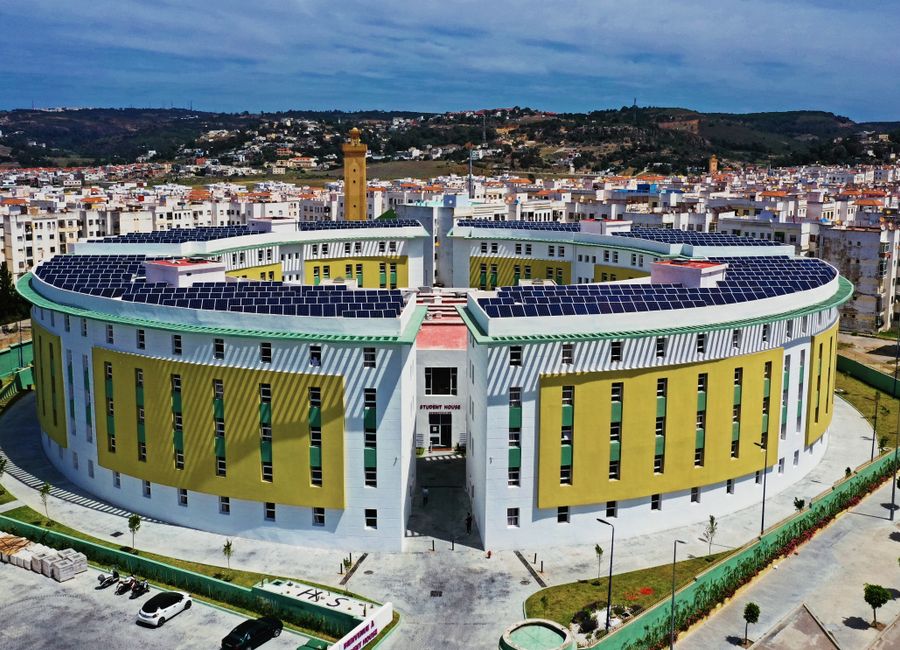Aerial view of a solar-paneled, circular modern building in Tangier, Morocco.