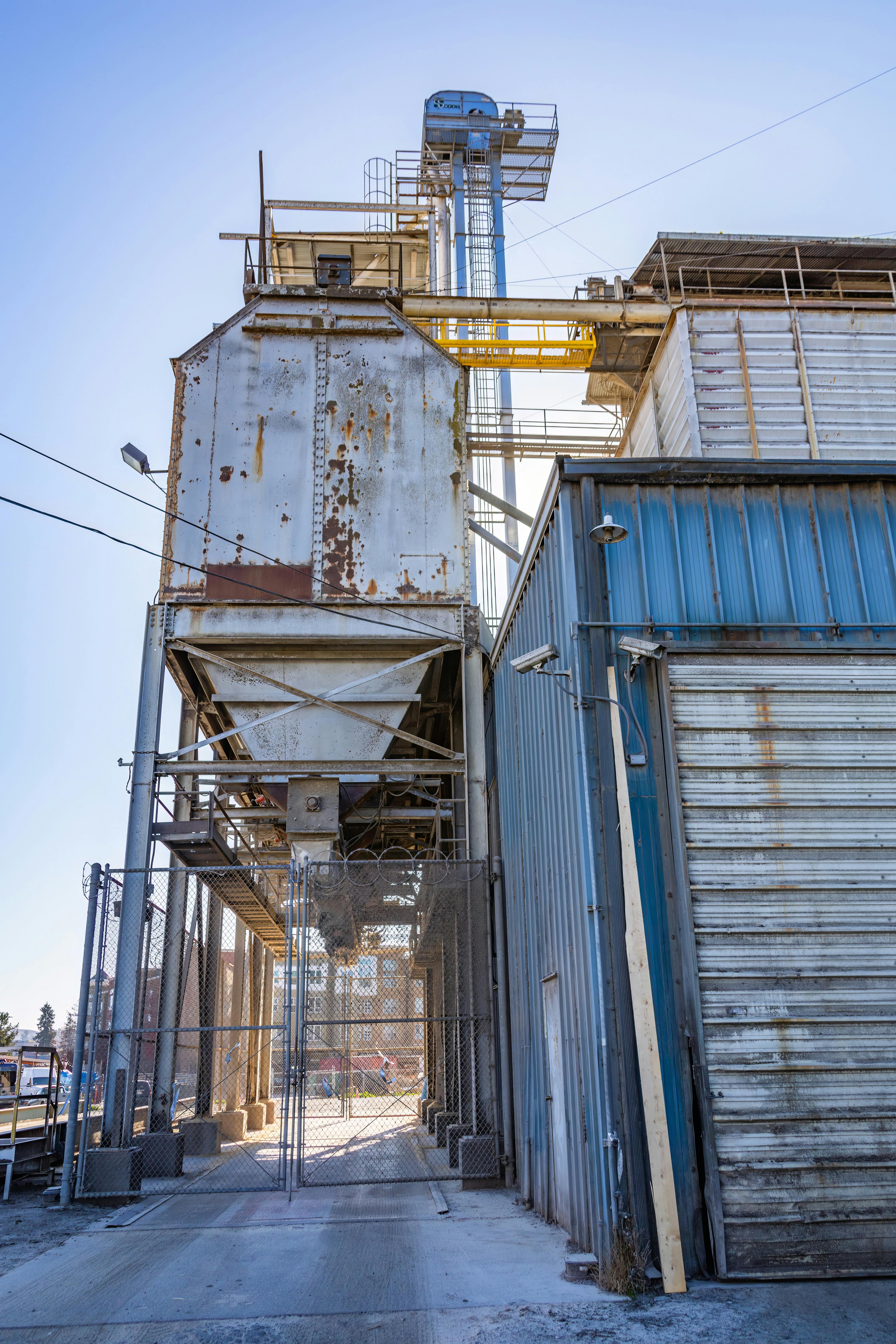 An industrial warehouse with large mesh gates. 