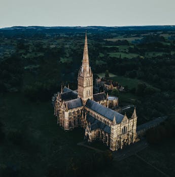 Stunning aerial shot of Salisbury Cathedral surrounded by lush countryside.