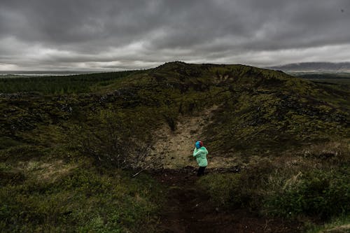 Person Kneeling on Green and Black Field