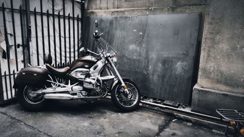 Free A classic cruiser motorcycle parked near an urban gate in Belgrade, Serbia's cityscape. Stock Photo