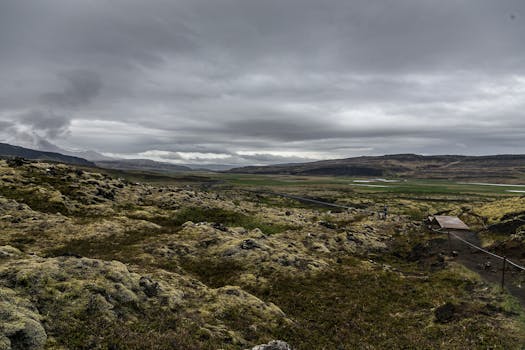 A stunning view of a rocky terrain under dramatic overcast skies, perfect for nature enthusiasts.