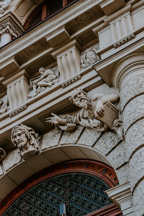 Free Close-up of ornate sculptures on a historic building's exterior facade. Stock Photo