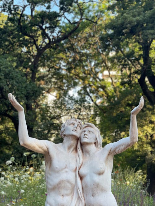 Couple Stone Sculptures in Green Garden