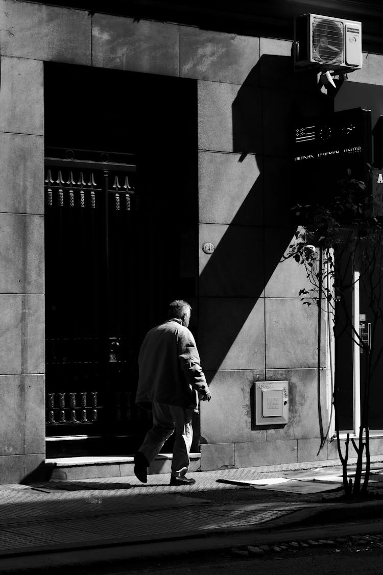 Pedestrian Walking Along City Street