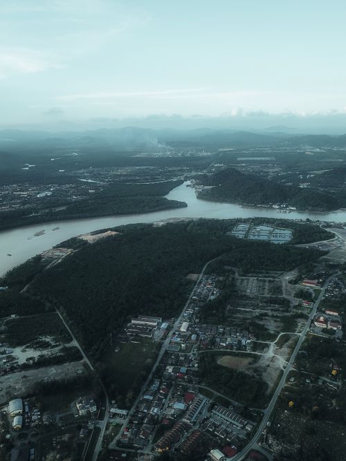 Free Scenic aerial view of Chukai town with lush green landscapes and winding river. Stock Photo