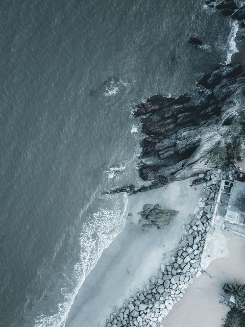 Free A stunning aerial view of Chukai's rocky coastline with waves hitting the shore, captured in Terengganu, Malaysia. Stock Photo